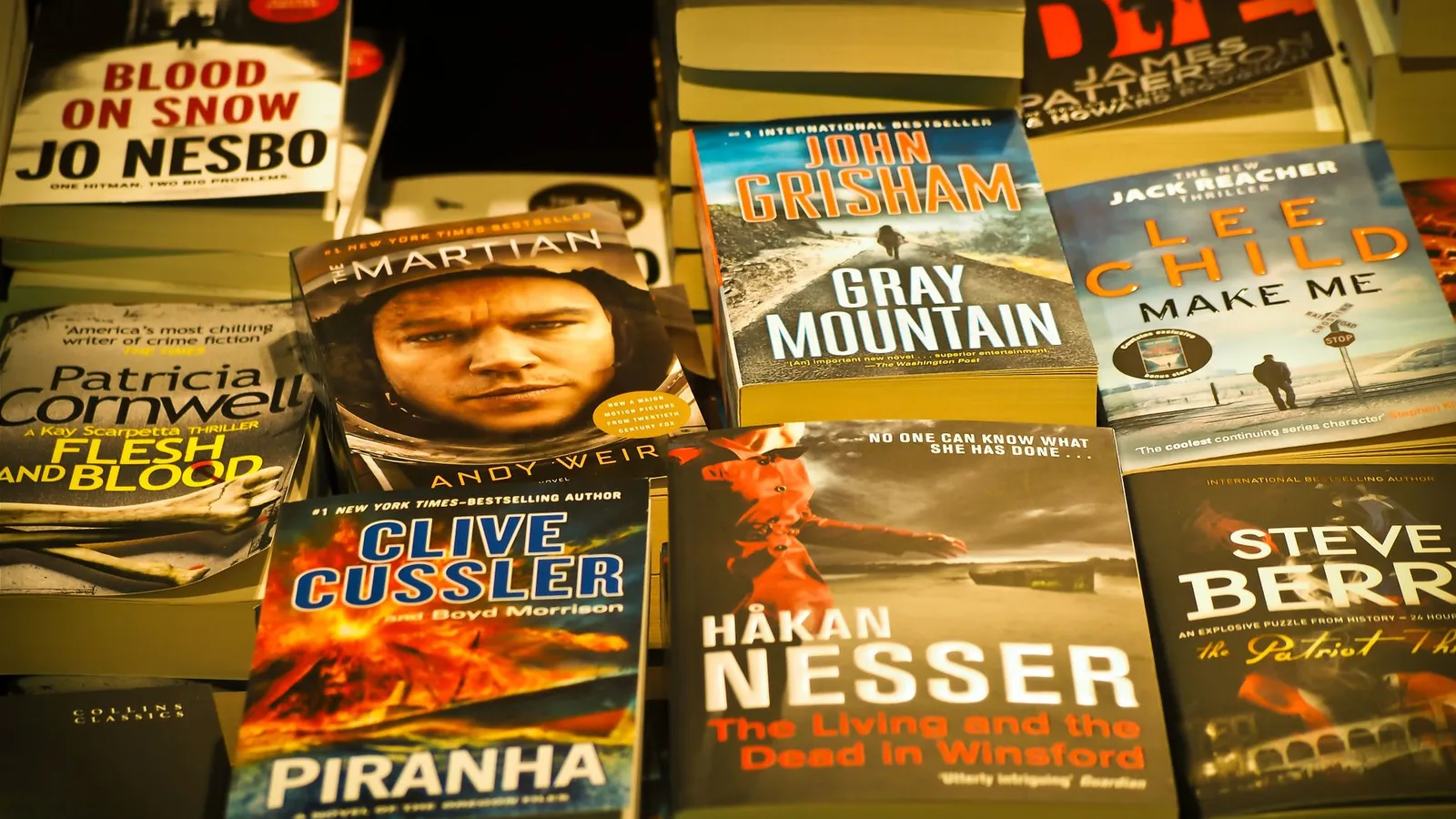 A collection of bestselling thriller novels prominently displayed in a bookstore setting.