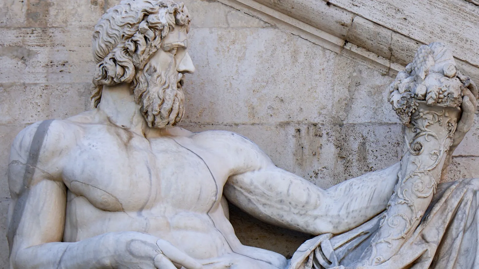 Close-up of Tiberinus, Roman god statue at Campidoglio, Rome, highlighting intricate details.