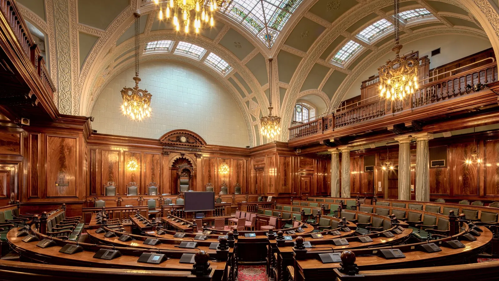A beautifully designed chamber room with ornate woodwork and chandeliers in the UK.