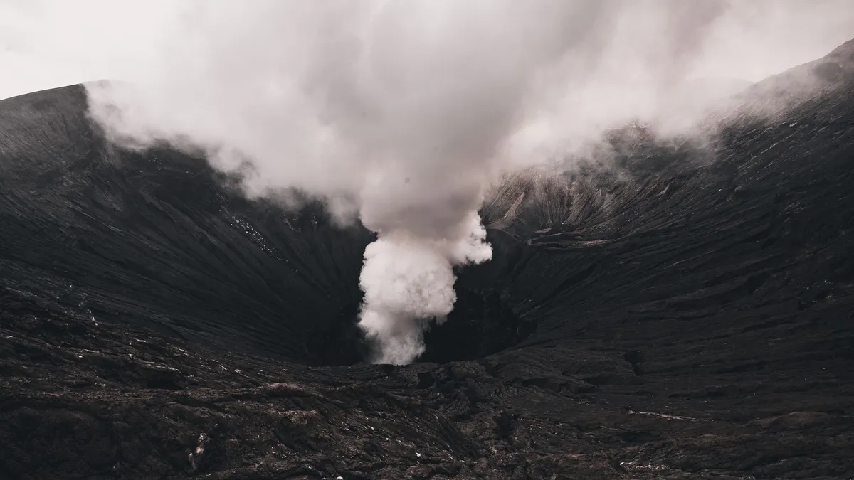 A powerful volcanic eruption emits dense smoke, illustrating nature's raw power.