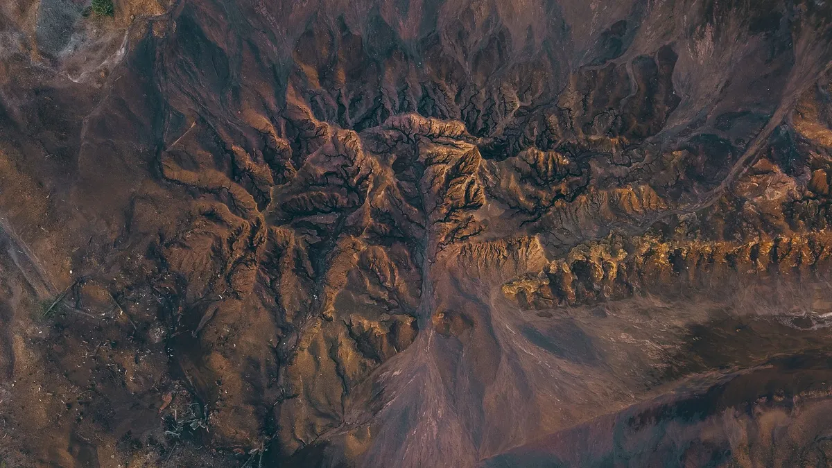 Spectacular aerial view of sandy canyon with dry uneven surface in highlands on sunny day — Photo by Pok Rie on Pexels